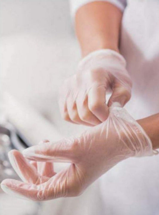 Photo of a person wearing vinyl exam gloves